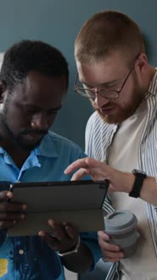 Young Men Working on Software For Digital Tablet