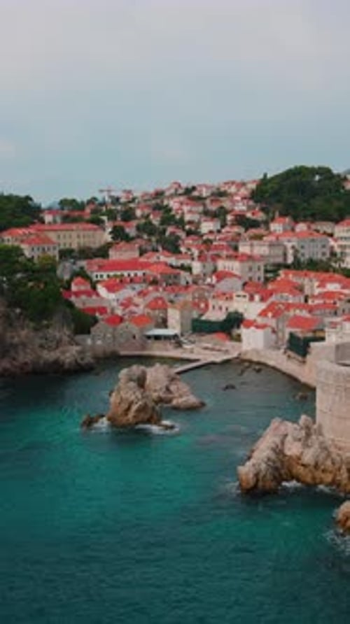 Vertical Drone Footage of Natural Beautiful Landscape View of Turquoise Tranquil Sea and Houses with