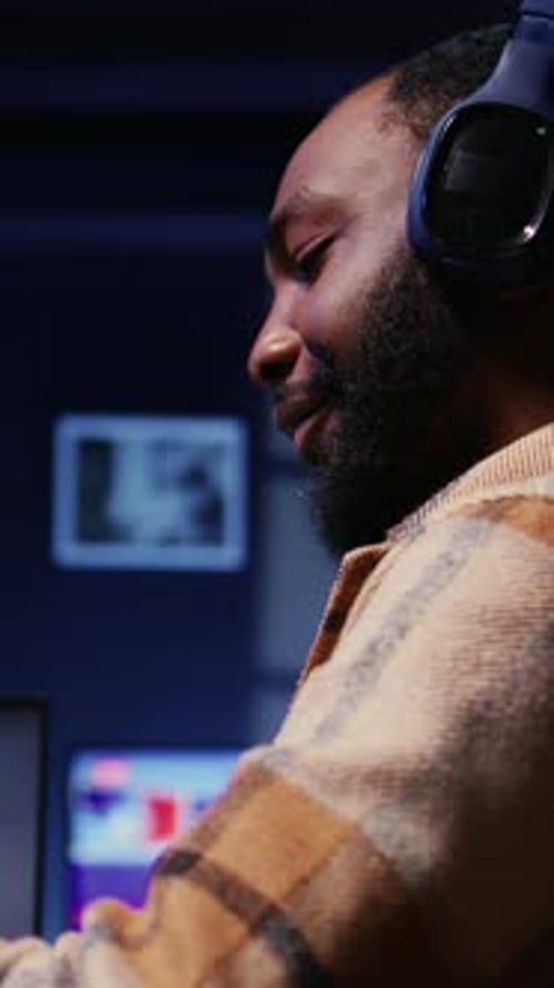 Vertical Video Host in Dimly Lit Studio Filming Internet Show Panning Shot