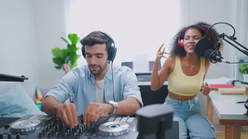 Diverse young stylish audio producer working in the music record studio.