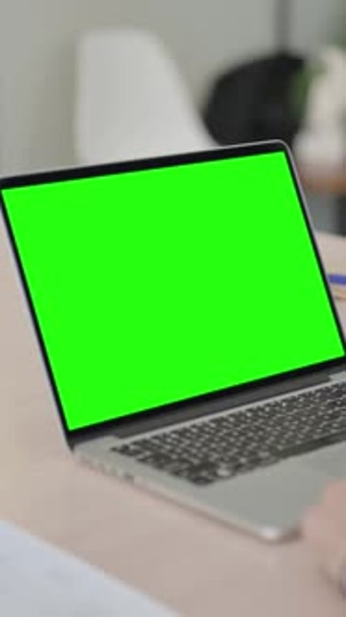 Man Using Laptop with Green Chroma Screen, Vertical Video