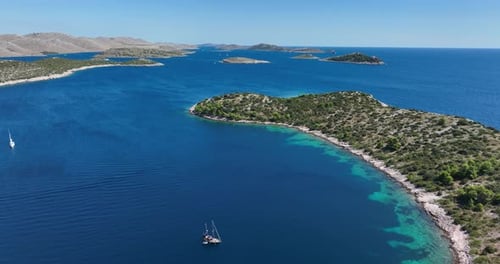 Stunning Aerial View of Sailboats Navigating Exotic Island Waters