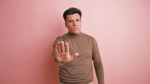 Serious Man Making a Stop Gesture with His Hand