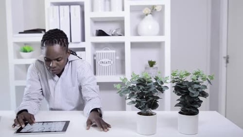 African American Man Working With Tablet Computer In Home Office