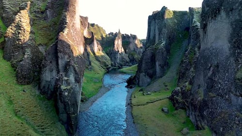 Majestic Fjadrargljufur Canyon in Iceland with Serene River and Lush Greenery