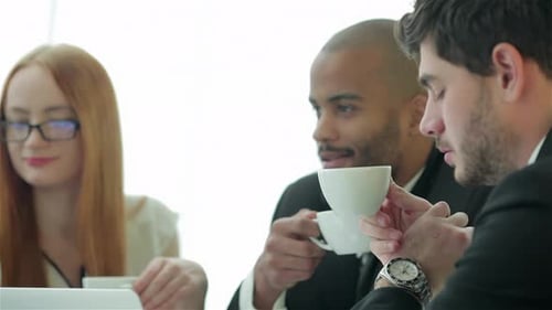 Business Team Having a Meeting with Coffee