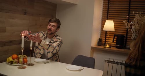 Happy Guy in a Checkered Shirt Together with His Girlfriend Create a Cozy Atmosphere and Light