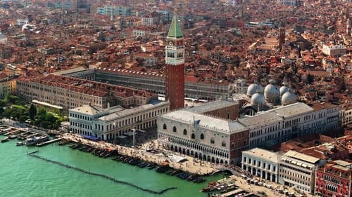 Aerial drone view of St. Mark's Square in Venice Italy, with the city on the background