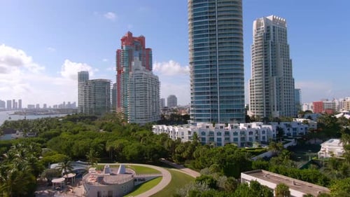 Aerial rise from ground revealing Miami skyline from Pointe Beach