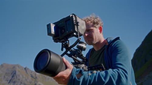 Man Using Professional Camera on Mountain