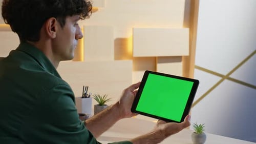 Freelancer Browsing Video Content at Green Screen Tablet Sitting Office Closeup