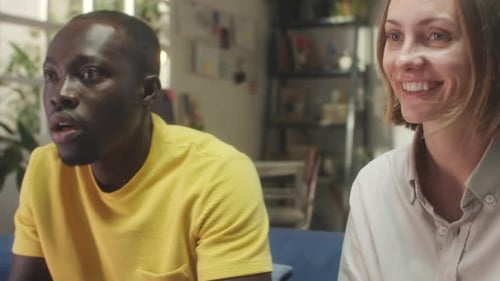 Friends Playing Video Games on Couch Indoors