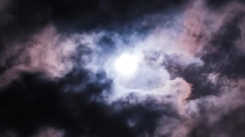 Moody Clouds Passing in Front of the Full Moon