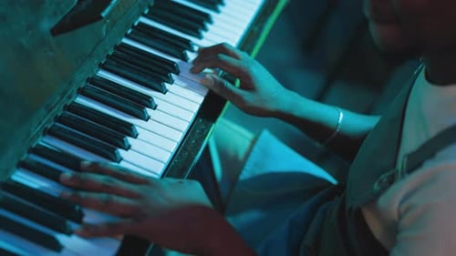 Man Plays Musical Piece on Piano in Club