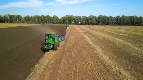 Tractors plowing the field in Ukraine