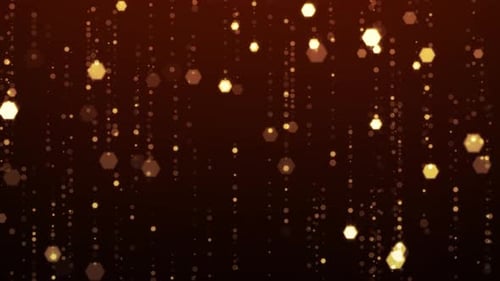 Golden glowing particles falling in soft shimmering motion