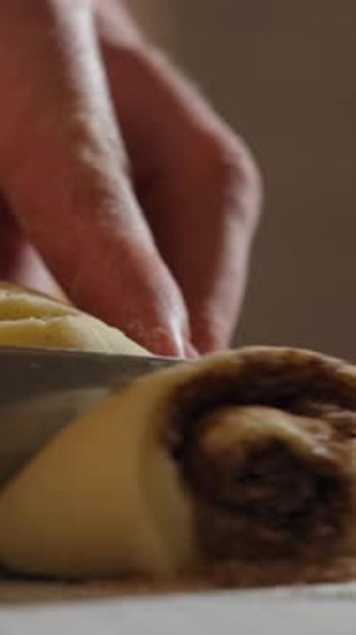 Cutting Homemade Cinnamon Roll with Knife, Sweet Treat