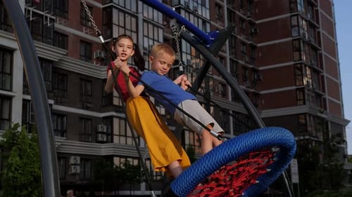Children Enjoying a Web Swing on Playground