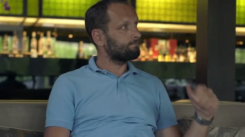 Impatient Man Waiting for Someone in Cafe and Checking Phone 30s