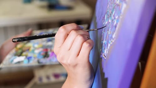 Artist Painting a Canvas with Intricate Pattern