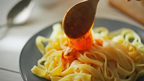 Close up of Pasta Being Sauced