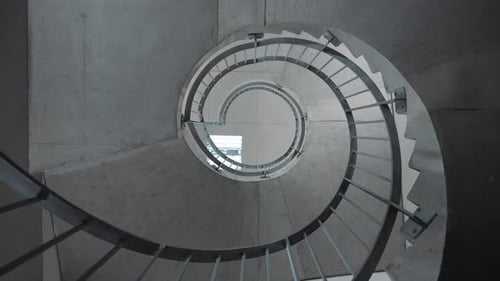 spinning shot of a beautiful stone spiral staircase within a hotel