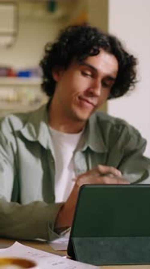 Focused Young Professionals Collaborating in Modern Cafe Setting Discussing Ideas and Reviewing