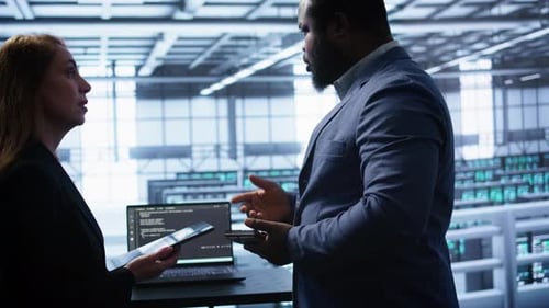 Teamworking Colleagues in Data Center Replacing Storage Rackmounts Components