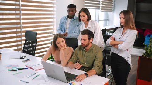 Diverse Team Collaborating on Project at Urban Workplace