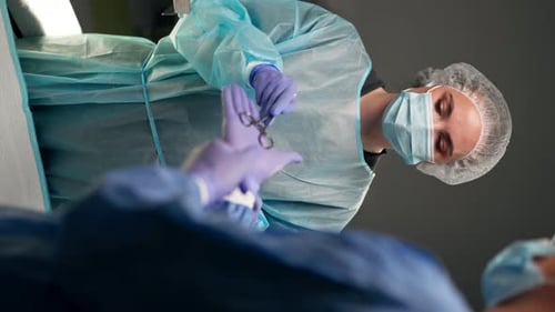 Vertical Video Close Up in Modern Clinic in a Bright Spacious Operating Room a Doctor a Surgeon in