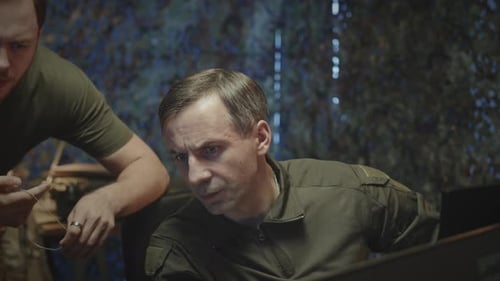 Military Officer Speaking with Colleagues at Cyber Security Center