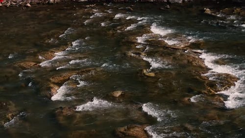 Fast flow of water on a mountain river. Beautiful mountain river.