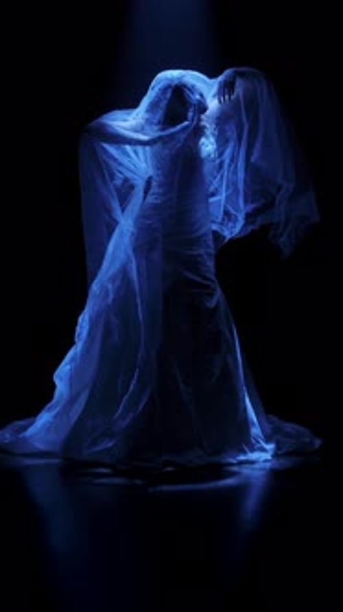 Woman Dancing Encased in Flowing Blue Fabric