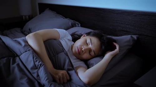 Asian woman sleeping at night