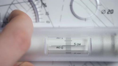 Macro Hand Moves Rolling Ruler Along Detail Drawing