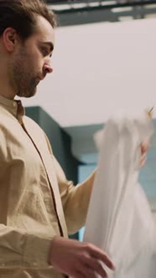 Young Adult Browsing Clothes Rack in Store