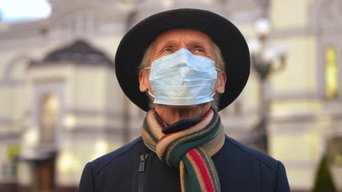Senior Man Wearing Face Mask Looks Upward