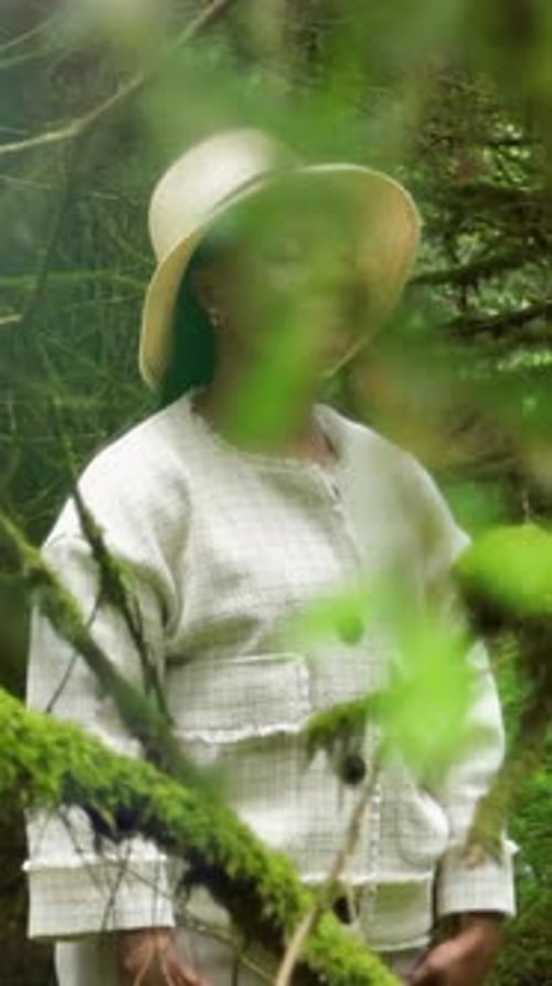 A Woman Embracing Nature in a Lush Green Forest Setting That is Full of Life and Beauty