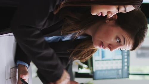 Vertical Video Real Estate Agency Employees Designing Building Blueprints