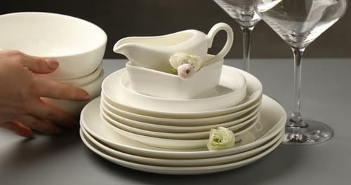 Elegant Table Setting with White China and Flowers