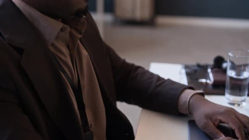 Black Developer Working on Laptop at Desk in Modern Office