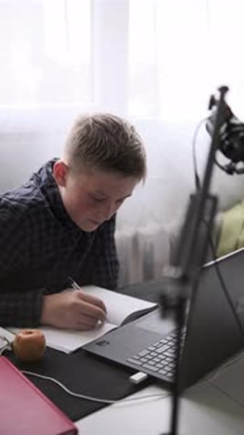 Teenager Studying Online with Laptop and Notebook Distance Learning and Education at Home