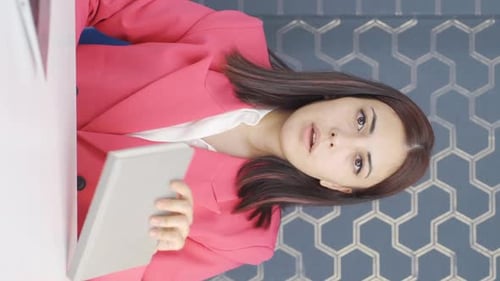 Woman Giving Online Presentation at Desk in Office
