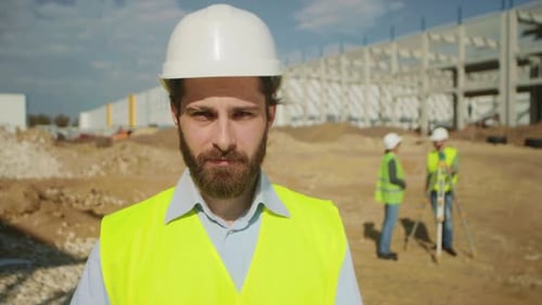 Construction Foreman in Hard Hat at Building Site