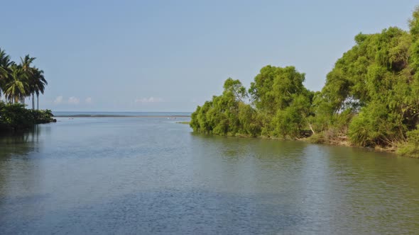 Aerial: people at remote surfing paradise, surf beach reveal from ...