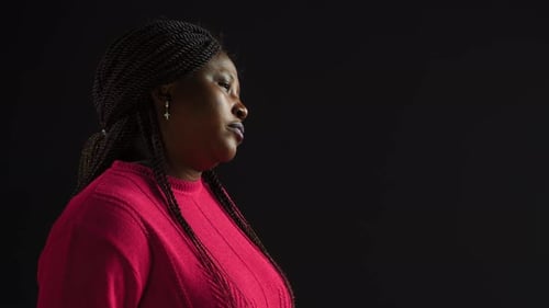 Woman Portrait with Braided Hair in Dark Room