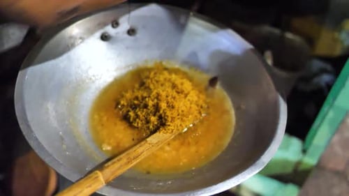 Close-up shot of the preparation process of the traditional Indonesian food "Kerak Telor". A person
