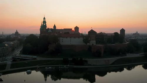 Drone footage of Wawel Royal Castle at magic dawn with soft, morning sunlight, Krakow, Poland