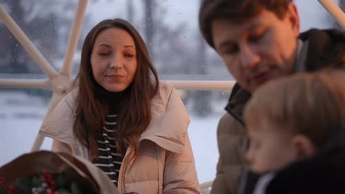 Family Sits Together on Snowy Day