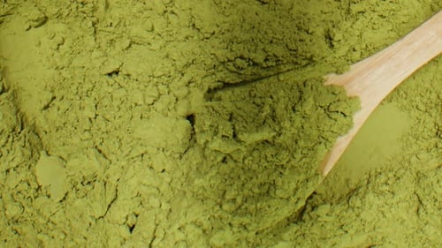 Matcha Green Tea Cooking Process Japanese Powder Green Tea in a Bowl with Bamboo Whisk Macro Close